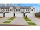 New construction townhomes boasting white garage doors, manicured lawns, and charming curb appeal at 322 Sound Cir # 118, Stockbridge, GA 30281