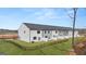 A full exterior shot of a newly constructed townhome community with private fenced backyards at 322 Sound Cir # 118, Stockbridge, GA 30281