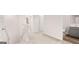 Upstairs hallway with neutral carpet, bright white walls, and open doors at 322 Sound Cir # 118, Stockbridge, GA 30281