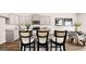 Well-designed kitchen with gray cabinets, stainless steel appliances, granite countertops, and a breakfast bar at 322 Sound Cir # 118, Stockbridge, GA 30281
