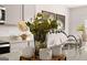Kitchen island with decorative vases and mugs sitting on quartz countertop with stainless steel faucet and sink at 322 Sound Cir # 118, Stockbridge, GA 30281