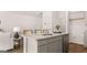 Kitchen island offers a breakfast bar with a sink, granite countertops and grey cabinets at 322 Sound Cir # 118, Stockbridge, GA 30281