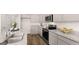 Modern kitchen with stainless steel appliances, granite countertops, and gray cabinets at 322 Sound Cir # 118, Stockbridge, GA 30281
