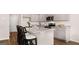 Well-lit kitchen featuring a spacious island, granite countertops, stainless steel appliances, and modern cabinets at 322 Sound Cir # 118, Stockbridge, GA 30281
