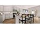 Modern kitchen features gray cabinets, granite countertops, stainless appliances, and breakfast bar seating at 322 Sound Cir # 118, Stockbridge, GA 30281