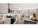 A well-lit kitchen featuring stainless steel appliances, gray cabinetry, and an adjacent breakfast nook at 322 Sound Cir # 118, Stockbridge, GA 30281