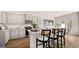 Modern kitchen with gray cabinets, stainless steel appliances, granite countertops, and a breakfast bar at 322 Sound Cir # 118, Stockbridge, GA 30281