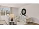 Bright living room features stylish decor, neutral palette, and large window with scenic outdoor views at 322 Sound Cir # 118, Stockbridge, GA 30281