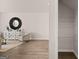 Bright living room with wood floors, a decorative mirror, and an adjacent walk-in closet at 322 Sound Cir # 118, Stockbridge, GA 30281
