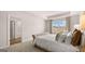 A tranquil main bedroom featuring tray ceilings, soft textures, and a view of the outside landscape at 322 Sound Cir # 118, Stockbridge, GA 30281