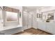 Modern bathroom featuring a soaking tub, glass-enclosed shower, double vanity, and stylish fixtures for a spa-like experience at 326 Sound Cir # 119, Stockbridge, GA 30281