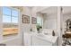 This bright bathroom features double sinks with modern fixtures and a view to an outside space at 326 Sound Cir # 119, Stockbridge, GA 30281