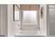Bathroom featuring soaking tub with stylish fixtures and window with patterned valance at 326 Sound Cir # 119, Stockbridge, GA 30281