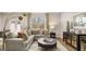 Stylish living room featuring a comfortable sectional sofa, modern decor, and large windows offering natural light at 326 Sound Cir # 119, Stockbridge, GA 30281