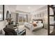Main bedroom with tray ceilings, neutral decor, stylish furniture, and a large window at 326 Sound Cir # 119, Stockbridge, GA 30281