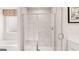 Modern bathroom featuring a glass-enclosed shower with marble-look tile and a tub by the window at 326 Sound Cir # 119, Stockbridge, GA 30281