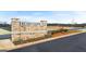 Welcome to Echo Glen community featuring a stone sign, landscaping, and paved roads at 326 Sound Cir # 119, Stockbridge, GA 30281