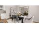 Bright dining area with modern decor, stylish chairs, and convenient access to the kitchen at 326 Sound Cir # 119, Stockbridge, GA 30281