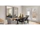 Elegant dining room with modern furniture, decorative mirrors, and access to the outdoors at 326 Sound Cir # 119, Stockbridge, GA 30281