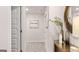 Bright hallway features neutral paint, carpet, entry door, console table with decor and a decorative mirror at 326 Sound Cir # 119, Stockbridge, GA 30281