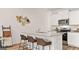Stylish kitchen with a breakfast bar, granite countertops, stainless steel appliances, and wood floors at 326 Sound Cir # 119, Stockbridge, GA 30281