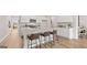 Modern kitchen with stainless steel appliances, white cabinets, an island, and three stools at 326 Sound Cir # 119, Stockbridge, GA 30281