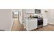 Modern kitchen featuring stainless steel appliances, granite countertops, and wood grain flooring at 326 Sound Cir # 119, Stockbridge, GA 30281