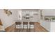 Well-lit kitchen with a breakfast bar, granite countertops, stainless steel appliances, and wood floors at 326 Sound Cir # 119, Stockbridge, GA 30281