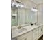 Bathroom vanity featuring double sinks and neutral-toned cabinets with modern lighting at 4438 Encore Park Xing, Duluth, GA 30097
