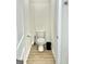 Half bathroom featuring wood floors, a toilet, and a trash can at 4438 Encore Park Xing, Duluth, GA 30097
