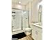 Bathroom with tile shower, tile floors, and a white vanity with sink at 4438 Encore Park Xing, Duluth, GA 30097