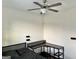Bedroom features a fan, desk, and dark wood floors at 4438 Encore Park Xing, Duluth, GA 30097