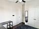 Bright bedroom featuring a fan, closet, and bed with dark wood floors at 4438 Encore Park Xing, Duluth, GA 30097