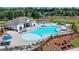 Community pool with ample seating, lounge chairs, and a clubhouse, perfect for relaxing and socializing at 4438 Encore Park Xing, Duluth, GA 30097
