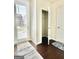 Bright entryway featuring hardwood floors, a coat closet and a door to the outside letting in natural light at 4438 Encore Park Xing, Duluth, GA 30097