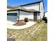 Side-entry garage with a gray door, a well-manicured lawn, and a concrete driveway at 4438 Encore Park Xing, Duluth, GA 30097