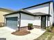 Side-entry garage with a gray door, a well-manicured lawn, and a concrete driveway at 4438 Encore Park Xing, Duluth, GA 30097