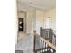 Upstairs hallway with wood railing, and laundry room at 4438 Encore Park Xing, Duluth, GA 30097