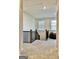 Open hallway with plush carpet and natural light from the window provides an inviting transition space at 4438 Encore Park Xing, Duluth, GA 30097