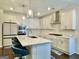 Modern kitchen with stainless steel appliances, quartz countertops, bar seating and ample white cabinetry at 4438 Encore Park Xing, Duluth, GA 30097