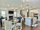 Open-concept living space with modern kitchen, fireplace, staircase, dining area, and comfortable seating at 4438 Encore Park Xing, Duluth, GA 30097