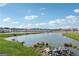 Scenic pond view in a residential neighborhood, showcasing peaceful waterfront scenery and landscaping at 4438 Encore Park Xing, Duluth, GA 30097
