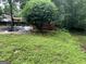 Backyard showcasing mature shade tree, patio, lush lawn and swimming pool at 275 Summertown Dr, Stockbridge, GA 30281