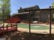 Home's backyard featuring a swimming pool, a large deck and mature trees at 275 Summertown Dr, Stockbridge, GA 30281