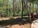 Backyard featuring mature trees and wooden fence surrounding perimeter at 275 Summertown Dr, Stockbridge, GA 30281