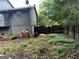 Backyard featuring a wood fence line, mature trees, and lush lawn at 275 Summertown Dr, Stockbridge, GA 30281