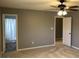 Spacious bedroom with ceiling fan, neutral carpet and paint, and natural light from the window at 275 Summertown Dr, Stockbridge, GA 30281