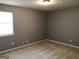 This bedroom has a neutral color scheme, a window for natural light, and carpeted floors at 275 Summertown Dr, Stockbridge, GA 30281