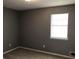 Comfortable bedroom with a window providing ample natural light, neutral walls, and carpeted flooring at 275 Summertown Dr, Stockbridge, GA 30281