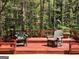 Outdoor deck with wooden chairs, ideal for enjoying the peaceful, wooded backyard at 275 Summertown Dr, Stockbridge, GA 30281